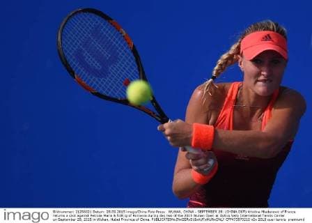 WUHAN, CHINA - SEPTEMBER 28: (CHINA OUT) Kristina Mladenovic of France returns a shot against Patricia Maria & 538;ig of Romania during day two of the 2015 Wuhan Open at Optics Vally International Tennis Center on September 28, 2015 in Wuhan, Hubei Province of China.  CFP473573210 