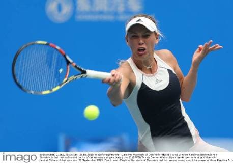 Caroline Wozniacki of Denmark returns a shot to Anna Karolina Schmiedlova of Slovakia in their second-round match of the women s singles during the 2015 WTA Tennis Damen Wuhan Open tennis tournament in Wuhan city, central China s Hubei province, 29 September 2015. Fourth seed Caroline Wozniacki of Denmark lost her second round match to unseeded Anna Karolina Schmiedlova of Slovakia 1-2 (6 1, 4 6, 6 7) in a marathon three hour match during the 2015 Wuhan Open on Tuesday (29 September 2015), further thinning out the ranks of the top seed players at the tournament. Fourth seed Wozniacki knocked out from Wuhan Open  20150929_13576