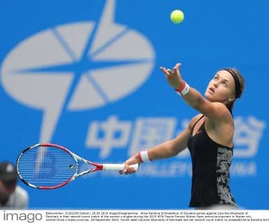 Anna Karolina Schmiedlova of Slovakia serves against Caroline Wozniacki of Denmark in their second-round match of the women s singles during the 2015 WTA Tennis Damen Wuhan Open tennis tournament in Wuhan city, central China s Hubei province, 29 September 2015. Fourth seed Caroline Wozniacki of Denmark lost her second round match to unseeded Anna Karolina Schmiedlova of Slovakia 1-2 (6 1, 4 6, 6 7) in a marathon three hour match during the 2015 Wuhan Open on Tuesday (29 September 2015), further thinning out the ranks of the top seed players at the tournament. Fourth seed Wozniacki knocked out from Wuhan Open  20150929_34603