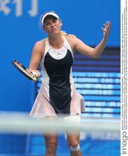 Caroline Wozniacki of Denmark reacts after losing scores to Anna Karolina Schmiedlova of Slovakia in their second-round match of the women s singles during the 2015 WTA Tennis Damen Wuhan Open tennis tournament in Wuhan city, central China s Hubei province, 29 September 2015. Fourth seed Caroline Wozniacki of Denmark lost her second round match to unseeded Anna Karolina Schmiedlova of Slovakia 1-2 (6 1, 4 6, 6 7) in a marathon three hour match during the 2015 Wuhan Open on Tuesday (29 September 2015), further thinning out the ranks of the top seed players at the tournament. Fourth seed Wozniacki knocked out from Wuhan Open  20150929_50766