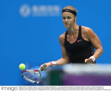 Anna Karolina Schmiedlova of Slovakia returns a shot to Caroline Wozniacki of Denmark in their second-round match of the women s singles during the 2015 WTA Tennis Damen Wuhan Open tennis tournament in Wuhan city, central China s Hubei province, 29 September 2015. Fourth seed Caroline Wozniacki of Denmark lost her second round match to unseeded Anna Karolina Schmiedlova of Slovakia 1-2 (6 1, 4 6, 6 7) in a marathon three hour match during the 2015 Wuhan Open on Tuesday (29 September 2015), further thinning out the ranks of the top seed players at the tournament. Fourth seed Wozniacki knocked out from Wuhan Open  20150929_13571