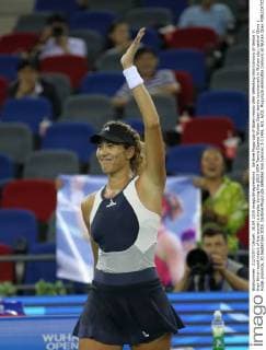 Garbine Muguruza of Spain reacts after defeating Ana Ivanovic of Serbia in their third-round match of the women s singles during the 2015 WTA Tennis Damen Wuhan Open tennis tournament in Wuhan city, central China s Hubei province, 30 September 2015. Garbine Muguruza defeated Ana Ivanovic 2-1 (4 6, 6 1, 6 0). Muguruza eliminates Ivanovic at Wuhan Open  pbu338844_35