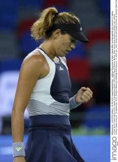 Garbine Muguruza of Spain reacts after scoring against Ana Ivanovic of Serbia in their third-round match of the women s singles during the 2015 WTA Tennis Damen Wuhan Open tennis tournament in Wuhan city, central China s Hubei province, 30 September 2015. Garbine Muguruza defeated Ana Ivanovic 2-1 (4 6, 6 1, 6 0). Muguruza eliminates Ivanovic at Wuhan Open  pbu338844_03