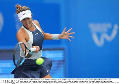 Garbine Muguruza of Spain returns a shot to Anna Schmiedlova of Slovakia in their quarter-final match of the women s singles during the 2015 WTA Tennis Damen Wuhan Open tennis tournament in Wuhan city, central China s Hubei province, 1 October 2015. Garbine Muguruza of Spain defeated Anna Schmiedlova of Slovakia 2-0 (6-2 6-2) in their quarter-final match of the women s singles during the 2015 WTA Wuhan Open tennis tournament in Wuhan city, central China s Hubei province, on Thursday (1 October 2015). Garbine Muguruza beats Anna Schmiedlova to advance at Wuhan Open  pbu339413_01
