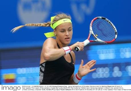 Anna Schmiedlova of Slovakia returns a shot to Garbine Muguruza of Spain in their quarter-final match of the women s singles during the 2015 WTA Tennis Damen Wuhan Open tennis tournament in Wuhan city, central China s Hubei province, 1 October 2015. Garbine Muguruza of Spain defeated Anna Schmiedlova of Slovakia 2-0 (6-2 6-2) in their quarter-final match of the women s singles during the 2015 WTA Wuhan Open tennis tournament in Wuhan city, central China s Hubei province, on Thursday (1 October 2015). Garbine Muguruza beats Anna Schmiedlova to advance at Wuhan Open  pbu339423_03