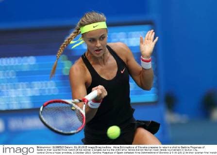Anna Schmiedlova of Slovakia prepares to return a shot to Garbine Muguruza of Spain in their quarter-final match of the women s singles during the 2015 WTA Tennis Damen Wuhan Open tennis tournament in Wuhan city, central China s Hubei province, 1 October 2015. Garbine Muguruza of Spain defeated Anna Schmiedlova of Slovakia 2-0 (6-2 6-2) in their quarter-final match of the women s singles during the 2015 WTA Wuhan Open tennis tournament in Wuhan city, central China s Hubei province, on Thursday (1 October 2015). Garbine Muguruza beats Anna Schmiedlova to advance at Wuhan Open  pbu339427_06
