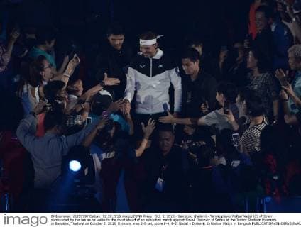 Oct. 2, 2015 - Bangkok, thailand - Tennis player Rafael Nadal (C) of Spain surrounded by the fan as he walks to the court ahead of an exhibition match against Novak Djokovic of Serbia at the Indoor Stadium Huamark in Bangkok, Thailand on October 2, 2015. Djokovic wins 2-0 set, score 6-4, 6-2. Nadal v Djokovic Exhibition Match in Bangkok  - ZUMAn230