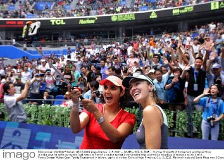 (151003) -- WUHAN, Oct. 3, 2015 -- Martina Hingis(R) of Switzerland and Sania Mirza of India pose for selfie during the final match of women s double against Irina-Camelia Begu and Monica Niculescu of Romania at 2015 WTA Tennis Damen Wuhan Open Tennis Tournament in Wuhan, capital of central China s Hubei Province, Oct. 3, 2015. Martina Hingis and Sania Mirza won 2-0 and claimed the title. ) (SP)CHINA-WUHAN-TENNIS-WTA-WUHAN OPEN (CN) ChengxMin 