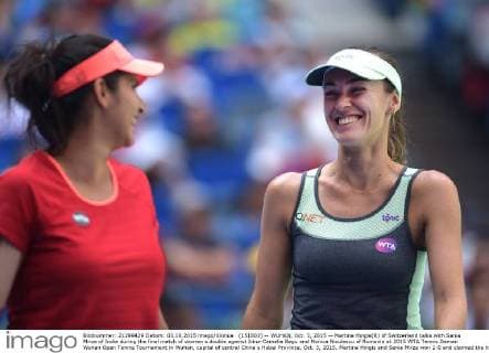 (151003) -- WUHAN, Oct. 3, 2015 -- Martina Hingis(R) of Switzerland talks with Sania Mirza of India during the final match of women s double against Irina-Camelia Begu and Monica Niculescu of Romania at 2015 WTA Tennis Damen Wuhan Open Tennis Tournament in Wuhan, capital of central China s Hubei Province, Oct. 3, 2015. Martina Hingis and Sania Mirza won 2-0 and claimed the title. ) (SP)CHINA-WUHAN-TENNIS-WTA-WUHAN OPEN (CN) ChengxMin 