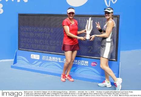 (151003) -- WUHAN, Oct. 3, 2015 -- Martina Hingis(R) of Switzerland and Sania Mirza of India pose with their trophy after winning the final match of women s double against Irina-Camelia Begu and Monica Niculescu of Romania at 2015 WTA Tennis Damen Wuhan Open Tennis Tournament in Wuhan, capital of central China s Hubei Province, Oct. 3, 2015. Martina Hingis and Sania Mirza won 2-0 and claimed the title. ) (SP)CHINA-WUHAN-TENNIS-WTA-WUHAN OPEN (CN) ChengxMin 