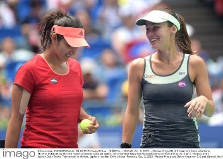 (151003) -- WUHAN, Oct. 3, 2015 -- Martina Hingis(R) of Switzerland talks with Sania Mirza of India during the final match of women s double against Irina-Camelia Begu and Monica Niculescu of Romania at 2015 WTA Tennis Damen Wuhan Open Tennis Tournament in Wuhan, capital of central China s Hubei Province, Oct. 3, 2015. Martina Hingis and Sania Mirza won 2-0 and claimed the title. ) (SP)CHINA-WUHAN-TENNIS-WTA-WUHAN OPEN (CN) ChengxMin 