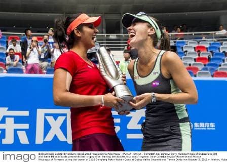 WUHAN, CHINA - OCTOBER 03: (CHINA OUT) Martina Hingis of Switzerland (R) and Sania Mirza of India pose with their trophy after winning the doubles final match against Irina-Camelia Begu of Romania and Monica Niculescu of Romania during day seven of 2015 Dongfeng Motor Wuhan Open at Optics Valley International Tennis Center on October 3, 2015 in Wuhan, Hubei Province of China.  CFP473797565 