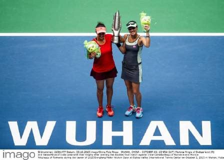 WUHAN, CHINA - OCTOBER 03: (CHINA OUT) Martina Hingis of Switzerland (R) and Sania Mirza of India pose with their trophy after winning the doubles final match against Irina-Camelia Begu of Romania and Monica Niculescu of Romania during day seven of 2015 Dongfeng Motor Wuhan Open at Optics Valley International Tennis Center on October 3, 2015 in Wuhan, Hubei Province of China.  CFP473797567 
