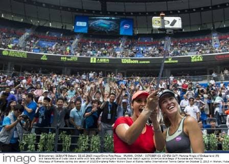 WUHAN, CHINA - OCTOBER 03: (CHINA OUT) Martina Hingis of Switzerland (R) and Sania Mirza of India take a selfie with fans after winning the doubles final match against Irina-Camelia Begu of Romania and Monica Niculescu of Romania during day seven of 2015 Dongfeng Motor Wuhan Open at Optics Valley International Tennis Center on October 3, 2015 in Wuhan, Hubei Province of China.  CFP473797586 