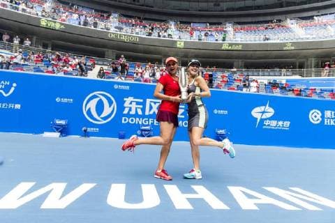 WUHAN, CHINA - OCTOBER 03: (CHINA OUT) Martina Hingis of Switzerland (R) and Sania Mirza of India pose with their trophy after winning the doubles final match against Irina-Camelia Begu of Romania and Monica Niculescu of Romania during day seven of 2015 Dongfeng Motor Wuhan Open at Optics Valley International Tennis Center on October 3, 2015 in Wuhan, Hubei Province of China.  CFP473797566 