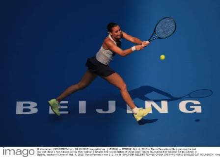 (151004) -- BEIJING, Oct. 4, 2015 -- Flavia Pennetta of Italy returns the ball against China s Han Xinyun during their women s singles first round match of China Open Tennis Tournament at National Tennis Center in Beijing, capital of China on Oct. 4, 2015. Flavia Pennetta won 2-1. )(wll) (SP)CHINA-BEIJING-TENNIS-CHINA OPEN-WOMEN S SINGLES-1ST ROUND(CN) XingxGuangli 