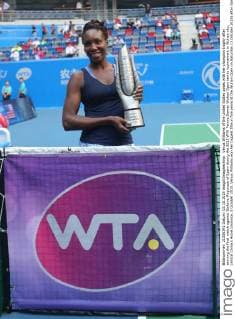 Venus Williams of the United States poses with her champion trophy after winning the final match against Garbine Muguruza of Spain during the 2015 WTA Tennis Damen Wuhan Open tennis tournament in Wuhan city, central China s Hubei province, 3 October 2015. Venus Williams won her biggest title in five years at the Wuhan Open on Saturday (3 October 2015) after Garbine Muguruza quitted, making her the fifth player to pull out mid-match in the late-season tournament. Williams took the first set and was three games up in the second when the Spaniard stopped play at 53 minutes, handing the American veteran the 47th title win of her career, and her first victory at a WTA Premier Five event since she beat Victoria Azarenka in 2010 in Dubai. Wimbledon finalist Muguruza, ranked world number eight, 16 places ahead of American veteran Williams, had a tough semi-final against Germany s Angelique Kerber, winning in straight sets but falling during the closing tie break and injuring her ankle. But the 21-year-old said it was exhaustion not injury that made her pull out. Venus wins 47th career title as Muguruza quits Wuhan Open final  20151003_63239