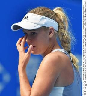 (151006) -- BEIJING, Oct. 6, 2015 -- Caroline Wozniacki of Danmark reacts during the women s singles second round match of China Open Tennis Tournament against Wang Qiang of China at the National Tennis Center in Beijing, capital of China, Oct. 6, 2015. Wozniacki won 2-0. ) (SP)CHINA-BEIJING-TENNIS-CHINA OPEN-WOMEN S SINGLES (CN) LixWen 