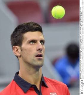 (151008) -- BEIJING, Oct. 8, 2015 -- Novak Djokovic of Serbia eyes the ball during the men s singles second round match against Zhang Ze of China at the China Open tennis tournament in Beijing, China, Oct. 8, 2015. Djokovic was qualified for the next round after beating Zhang 2-0. ) (SP)CHINA-BEIJING-TENNIS-CHINA OPEN-MEN S SINGLES-DJOKOVIC LixWen 