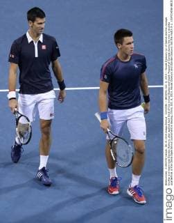 (151008) -- BEIJING, Oct. 8, 2015 -- Novak Djokovic (L) of Serbia and his younger brother and teammate Djordje Djokovic play against Jack Sock of the United States and Vasek Pospisil of Canada during the men s doubles quarterfinal at the China Open tennis tournament in Beijing, China, Oct. 8, 2015. Novak Djokovic and Djordje Djokovic lost the match 0-2. ) (SP)CHINA-BEIJING-TENNIS-CHINA OPEN-MEN S DOUBLES-QUARTER FINAL XingxGuangli 