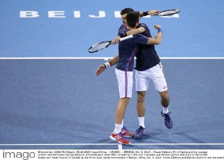 (151008) -- BEIJING, Oct. 8, 2015 -- Novak Djokovic (R) of Serbia and his younger brother and teammate Djordje Djokovic embraces each other after competing in the men s doubles quarterfinal against Jack Sock of the United States and Vasek Pospisil of Canada at the China Open tennis tournament in Beijing, China, Oct. 8, 2015. Novak Djokovic and Djordje Djokovic lost the match 0-2. ) (SP)CHINA-BEIJING-TENNIS-CHINA OPEN-MEN S DOUBLES-QUARTER FINAL XingxGuangli 