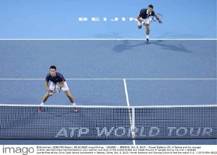 (151008) -- BEIJING, Oct. 8, 2015 -- Novak Djokovic (R) of Serbia and his younger brother and teammate Djordje Djokovic play against Jack Sock of the United States and Vasek Pospisil of Canada during the men s doubles quarterfinal at the China Open tennis tournament in Beijing, China, Oct. 8, 2015. Novak Djokovic and Djordje Djokovic lost the match 0-2. ) (SP)CHINA-BEIJING-TENNIS-CHINA OPEN-MEN S DOUBLES-QUARTER FINAL XingxGuangli 