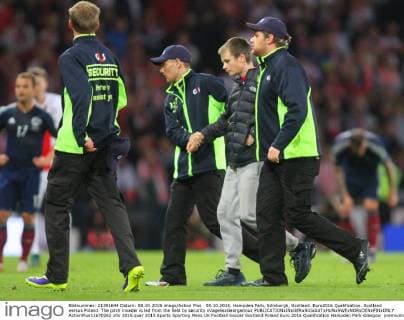 08.10.2015. Hampden Park, Edinburgh, Scotland. Euro2016 Qualification. Scotland versus Poland. The pitch invader is led from the field by security xVagelisxGeorgarioux  ActionPlus11670262
