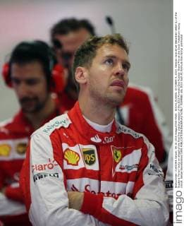 SOCHI, RUSSIA. OCTOBER 9, 2015. German race driver Sebastian Vettel (L) of the Scuderia Ferrari looks on ahead of the first free practice session of the 2015 Formula One Russian Grand Prix at the Sochi Autodrom racing circuit. Sergei Savostyanov TASS  TS00F6E1