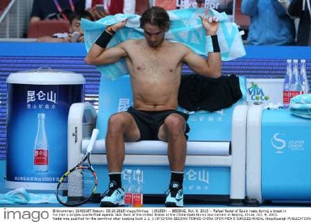 (151009) -- BEIJING, Oct. 9, 2015 -- Rafael Nadal of Spain rests during a break in his men s singles quarterfinal against Jack Sock of the United States at the China Open tennis tournament in Beijing, China, Oct. 9, 2015. Nadal was qualified for the semifinal after beating Sock 2-1. ) (SP)CHINA-BEIJING-TENNIS-CHINA OPEN-MEN S SINGLES-NADAL XingxGuangli 