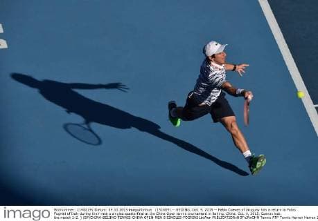 (151009) -- BEIJING, Oct. 9, 2015 -- Pablo Cuevas of Uruguay hits a return to Fabio Fognini of Italy during their men s singles quarterfinal at the China Open tennis tournament in Beijing, China, Oct. 9, 2015. Cuevas lost the match 1-2. ) (SP)CHINA-BEIJING-TENNIS-CHINA OPEN-MEN S SINGLES-FOGNINI LixWen 