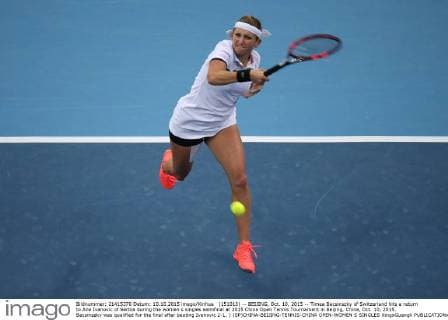 (151010) -- BEIJING, Oct. 10, 2015 -- Timea Bacsinszky of Switzerland hits a return to Ana Ivanovic of Serbia during the women s singles semifinal at 2015 China Open Tennis Tournament in Beijing, China, Oct. 10, 2015. Bacsinszky was qualified for the final after beating Ivanovic 2-1. ) (SP)CHINA-BEIJING-TENNIS-CHINA OPEN-WOMEN S SINGLES XingxGuangli 