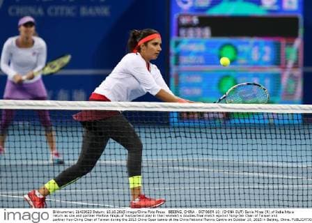 BEIJING, CHINA - OCTOBER 10: (CHINA OUT) Sania Mirza (R) of India hits a return as she and partner Martina Hingis of Switzerland play in their women s doubles final match against Yung-Jan Chan of Taiwan and partner Hao-Ching Chan of Taiwan during the 2015 China Open tennis at the China National Tennis Centre on October 10, 2015 in Beijing, China.  CFP474184495 