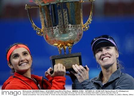BEIJING, CHINA - OCTOBER 10: (CHINA OUT) Martina Hingis (R) of Switzerland and partner Sania Mirza of India celebrates with the trophy after winning their women s doubles final match against Yung-Jan Chan of Taiwan and partner Hao-Ching Chan of Taiwan during the 2015 China Open tennis at the China National Tennis Centre on October 10, 2015 in Beijing, China.  CFP474184499 