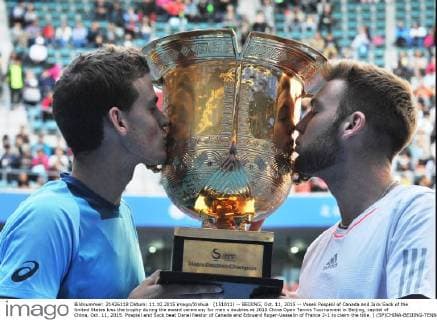 (151011) -- BEIJING, Oct. 11, 2015 -- Vasek Pospisil of Canada and Jack Sock of the United States kiss the trophy during the award ceremony for men s doubles at 2015 China Open Tennis Tournament in Beijing, capital of China, Oct. 11, 2015. Pospisil and Sock beat Danel Nestor of Canada and Edouard Roger-Vasselin of France 2-1 to claim the title. ) (SP)CHINA-BEIJING-TENNIS-CHINA OPEN-MEN S DOUBLES LixWen 