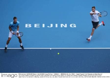 (151011) -- BEIJING, Oct. 11, 2015 -- Vasek Pospisil (L)of Canada and Jack Sock of the United States compete during the men s doubles final against Danel Nestor of Canada and Edouard Roger-Vasselin of France at 2015 China Open Tennis Tournament in Beijing, capital of China, Oct. 11, 2015. Pospisil and Sock won 2-1 to claim the title. ) (SP)CHINA-BEIJING-TENNIS-CHINA OPEN-MEN S DOUBLES XingxGuangli 