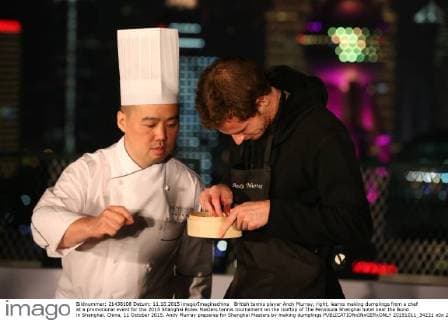 British tennis player Andy Murray, right, learns making dumplings from a chef at a promotional event for the 2015 Shanghai Rolex Masters tennis tournament on the rooftop of The Peninsula Shanghai hotel near the Bund in Shanghai, China, 11 October 2015. Andy Murray prepares for Shanghai Masters by making dumplings  20151011_34221