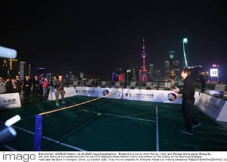 British tennis player Andy Murray, right, and Chinese tennis player Zhang Ze, left, play tennis at a promotional event for the 2015 Shanghai Rolex Masters tennis tournament on the rooftop of The Peninsula Shanghai hotel near the Bund in Shanghai, China, 11 October 2015. Andy Murray prepares for Shanghai Masters by making dumplings  20151011_65180