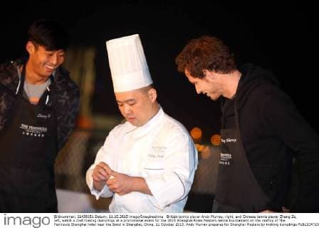 British tennis player Andy Murray, right, and Chinese tennis player Zhang Ze, left, watch a chef making dumplings at a promotional event for the 2015 Shanghai Rolex Masters tennis tournament on the rooftop of The Peninsula Shanghai hotel near the Bund in Shanghai, China, 11 October 2015. Andy Murray prepares for Shanghai Masters by making dumplings  pbu343612_01