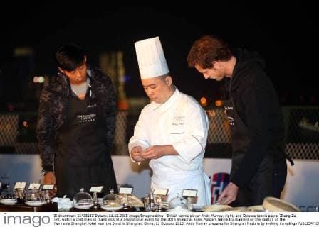British tennis player Andy Murray, right, and Chinese tennis player Zhang Ze, left, watch a chef making dumplings at a promotional event for the 2015 Shanghai Rolex Masters tennis tournament on the rooftop of The Peninsula Shanghai hotel near the Bund in Shanghai, China, 11 October 2015. Andy Murray prepares for Shanghai Masters by making dumplings  pbu343612_16
