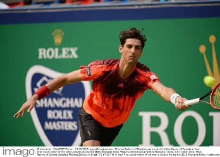 Thomaz Bellucci of Brazil returns a shot to Milos Raonic of Canada in their first round match of the men s singles during the 2015 Shanghai Rolex Masters tennis tournament in Shanghai, China, 13 October 2015. Milos Raonic of Canada defeated Thomaz Bellucci of Brazil 2-0 (7-6 7-6) in their first round match of the men s singles during the 2015 Shanghai Rolex Masters tennis tournament in Shanghai, China, 13 October 2015. Milos Raonic ousts Thomaz Bellucci at Shanghai Rolex Masters  20151013_09742