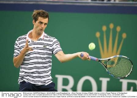 Albert Ramos-Vinolas of Spain returns a shot to Roger Federer of Switzerland during their men s singles second round match of the 2015 Shanghai Rolex Masters tennis tournament in Shanghai, China, 13 October 2015. World number three and defending champion Roger Federer suffered a surprise defeat in the second round of the Shanghai Masters on Tuesday (13 October 2015), losing 7-6(4) 2-6 6-3 to Spain s Albert Ramos-Vinolas. The Swiss, returning to action after a month off, looked rusty against the 70th-ranked qualifier and despite appearing to be back on track when he cruised through the second set, he succumbed in the decider to a single break of serve in the eighth game. Roger Federer knocked out in Shanghai Masters opener  20151014_04753
