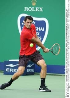 Bernard Tomic of Australia returns a shot to David Ferrer of Spain in their second round match of the men s singles during the 2015 Shanghai Rolex Masters tennis tournament in Shanghai, China, 14 October 2015. Bernard Tomic of Australia defeated David Ferrer of Spain 2-0 (6-4 6-2) in their second round match of the men s singles during the 2015 Shanghai Rolex Masters tennis tournament in Shanghai, China, 14 October 2015. David Ferrer kicked out by Bernard Tomic at Shanghai Rolex Masters  pbu344939_02