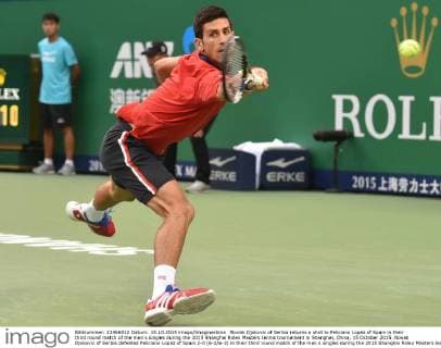 Novak Djokovic of Serbia returns a shot to Feliciano Lopez of Spain in their third round match of the men s singles during the 2015 Shanghai Rolex Masters tennis tournament in Shanghai, China, 15 October 2015. Novak Djokovic of Serbia defeated Feliciano Lopez of Spain 2-0 (6-2 6-3) in their third round match of the men s singles during the 2015 Shanghai Rolex Masters tennis tournament in Shanghai, China, 15 October 2015. Novak Djokovic conquers Feliciano Lopez at Shanghai Rolex Masters  20151015_10597