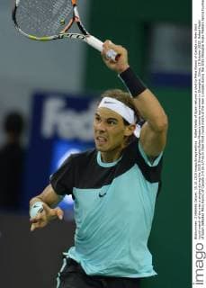 Rafael Nadal of Spain returns a shot to Milos Raonic of Canada in their third round match of the men s singles during the 2015 Shanghai Rolex Masters tennis tournament in Shanghai, China, 15 October 2015. Rafael Nadal of Spain defeated Milos Raonic of Canada 2-0 (6-3 7-6) in their third round match of the men s singles during the 2015 Shanghai Rolex Masters tennis tournament in Shanghai, China, 15 October 2015. Rafael Nadal ousts Milos Raonic at Shanghai Rolex Masters  20151015_12370