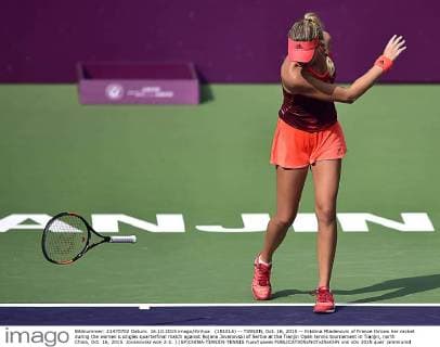 (151016) -- TIANJIN, Oct. 16, 2015 -- Kristina Mladenovic of France throws her racket during the women s singles quarterfinal match against Bojana Jovanovski of Serbia at the Tianjin Open tennis tournament in Tianjin, north China, Oct. 16, 2015. Jovanovski won 2-1. ) (SP)CHINA-TIANJIN-TENNIS YuexYuewei 
