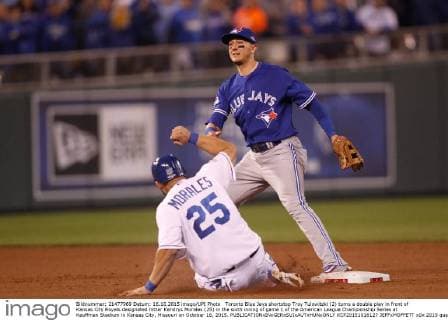 Toronto Blue Jays shortstop Troy Tulowitzki (2) turns a double play in front of Kansas City Royals designated hitter Kendrys Morales (25) in the sixth inning of game 1 of the American League Championship Series at Kauffman Stadium in Kansas City, Missouri on October 16, 2015.  KCP20151016127 JEFFxMOFFETT
