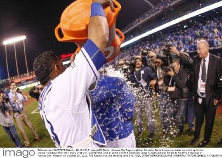 Kansas City Royals catcher Salvador Perez dumps ice-water on winning pitcher Edinson Volquez after the victory over the Toronto Blue Jays in game 1 of the American League Championship Series at Kauffman Stadium in Kansas City, Missouri on October 16, 2015. The Royals shut out the Blue Jays 5-0.  KCP20151016219 KYLExRIVAS