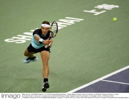 Rafael Nadal of Spain returns a shot to Jo-Wilfried Tsonga of France in their semi-final match of the men s singles during the 2015 Shanghai Rolex Masters tennis tournament in Shanghai, China, 17 October 2015. Jo-Wilfried Tsonga of France defeated Rafael Nadal of Spain 2-1 (6-4 0-6 7-5) in their semi-final match of the men s singles during the 2015 Shanghai Rolex Masters tennis tournament in Shanghai, China, 17 October 2015. Jo-Wilfried Tsonga ousts Rafael Nadal to advance to final at Shanghai Rolex Masters  20151017_32322