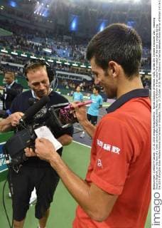 Novak Djokovic of Serbia, right, writes the Chinese character Zan , meaning Good in English, on the lens of a video camera after defeating Andy Murray of Britain in their semi-final match of the men s singles during the 2015 Shanghai Rolex Masters tennis tournament in Shanghai, China, 17 October 2015. Novak Djokovic of Serbia defeated Andy Murray of Britain 2-0 (6-1 6-3) in their semi-final match of the men s singles during the 2015 Shanghai Rolex Masters tennis tournament in Shanghai, China, 17 October 2015. Novak Djokovic eliminates Andy Murray to advance to final at Shanghai Rolex Masters  20151017_64918