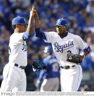 Kansas City Royals Yordano Ventura (L) high fives shortstop Alcides Escobar after a diving catch catch by Escobar of a liner by Toronto Blue Jays Russell Martin lead to a double play in the second inning of game 2 of the American League Championship Series at Kauffman Stadium in Kansas City, Missouri on October 17, 2015.  KCP20151017215 JEFFxMOFFETT
